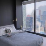 bedroom-with-a-black-wall-and-large-windows