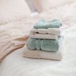 neatly-folded-towels-placed-on-a-bed