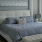 photo-of-a-bed-with-a-white-bed-frame-and-blue-sheets