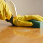 spaying-cleaner-on-wood